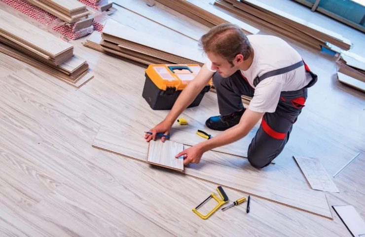 man installing laminate flooring